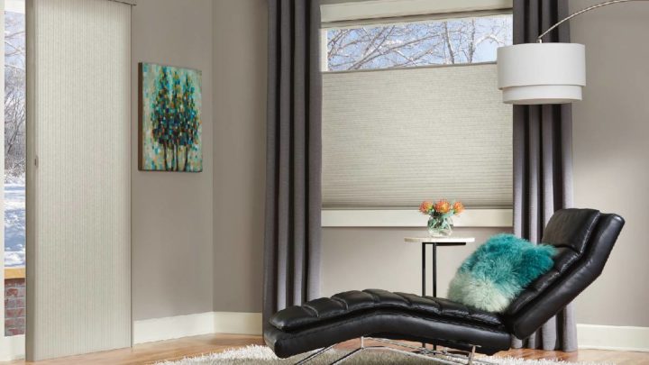 Sitting room with black leather lounge chair and Hunter Douglas Duette® Cellular Shades on the windows at White House Designs For Life near Fairfield, New Jersey