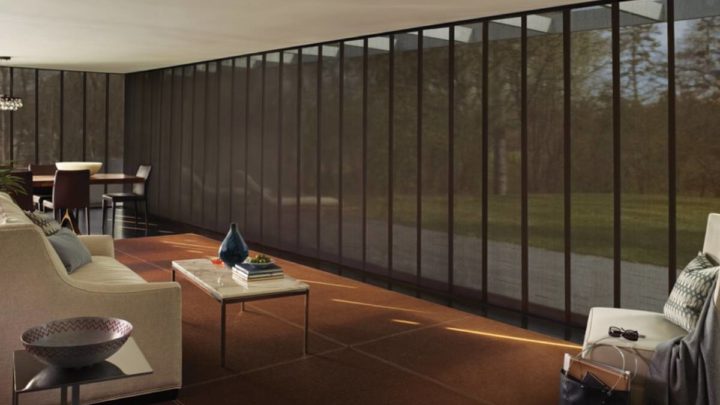 Living room with an expansive window covered with Hunter Douglas Skyline® Gliding Window Panels at White House Designs for Life near Fairfield, NY