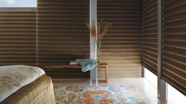 Partially open Hunter Douglas Vignette® Roman Shades as blackout shades in a cozy, neutral bedroom at White House Designs For Life near New Jersey (NJ)