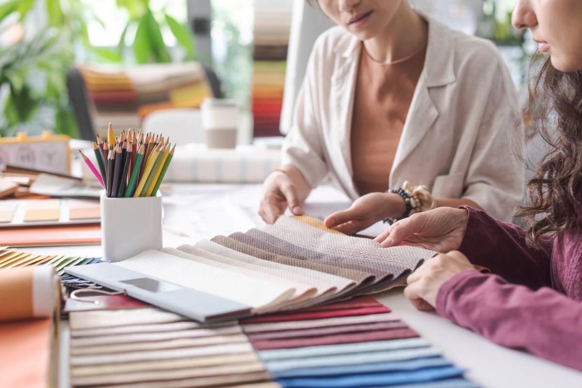 A custom window treatment expert working with a client, going over custom fabric swatches at White House Designs For Life near New Jersey (NJ)