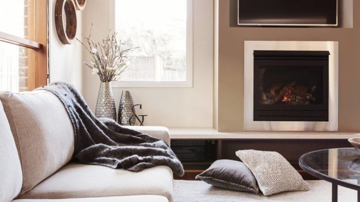 Luxe living room design featuring metallic vases, cozy throw pillows and blankets, and sleek hardware at White House Designs for Life near Chester, NJ