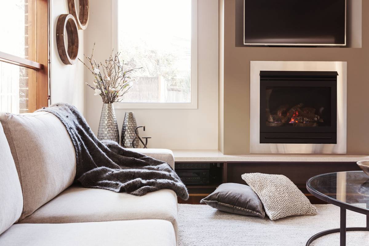 Luxe living room design featuring metallic vases, cozy throw pillows and blankets, and sleek hardware at White House Designs for Life near Chester, NJ