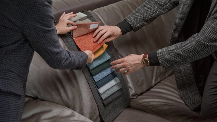 An image of two designers exploring interior design fabric swatches for a sectional couch